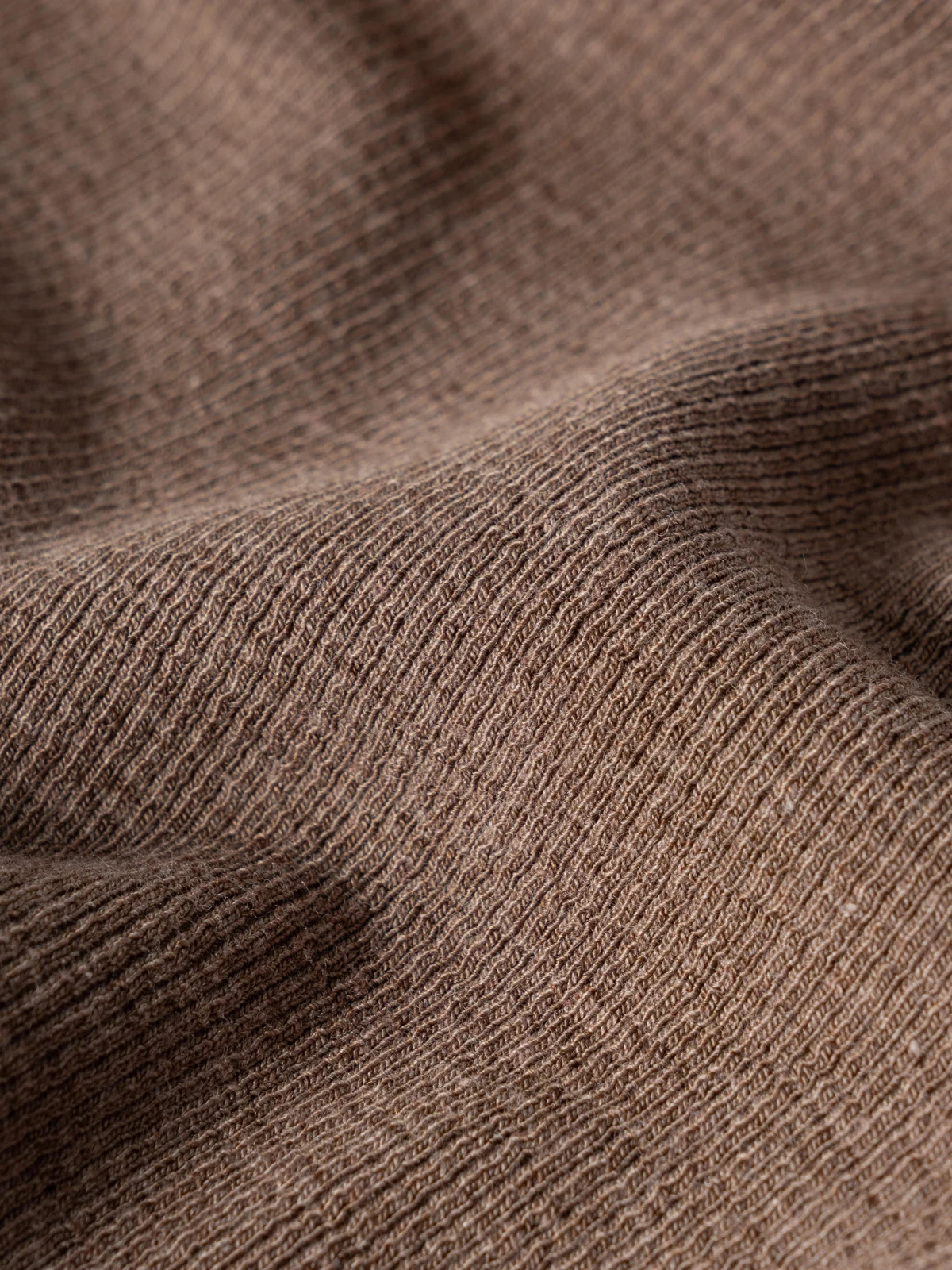 Looped fabric surface; stretch requires verification