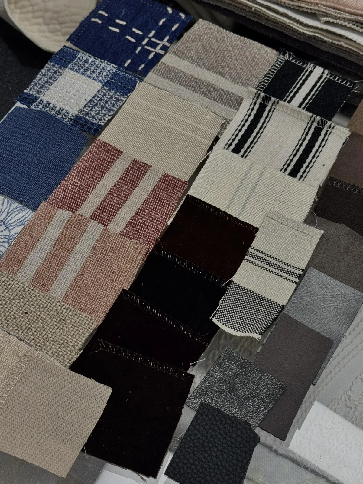 Assorted fabric swatches arranged in a woven textile reference book.