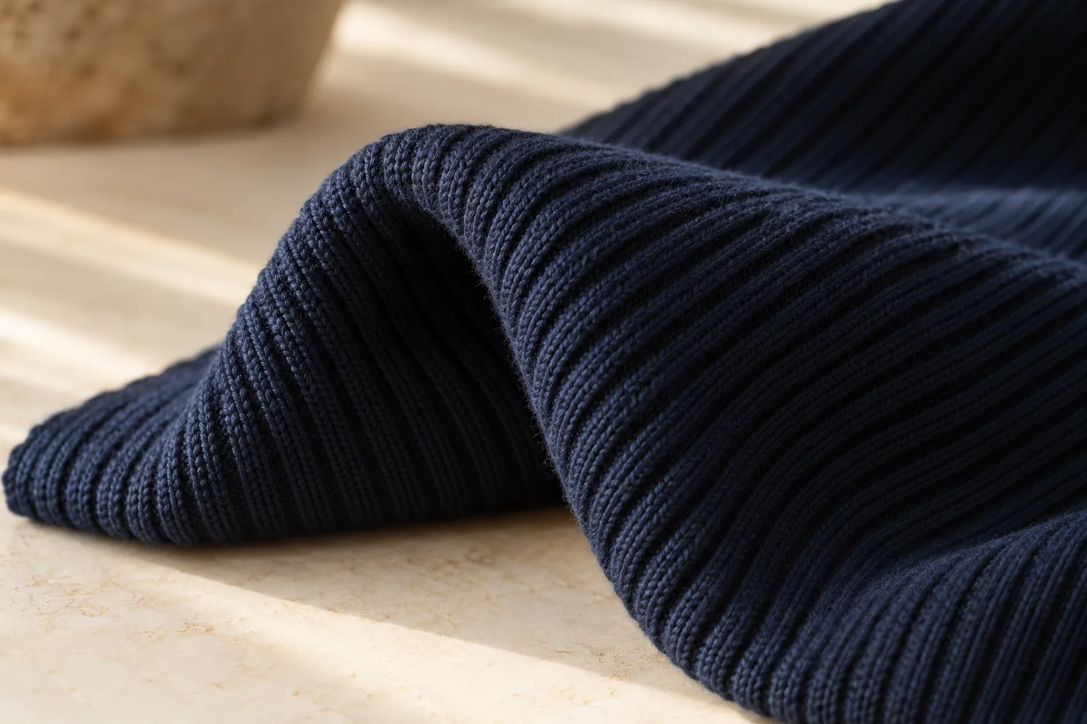 Navy rib knit folded into a soft loop.