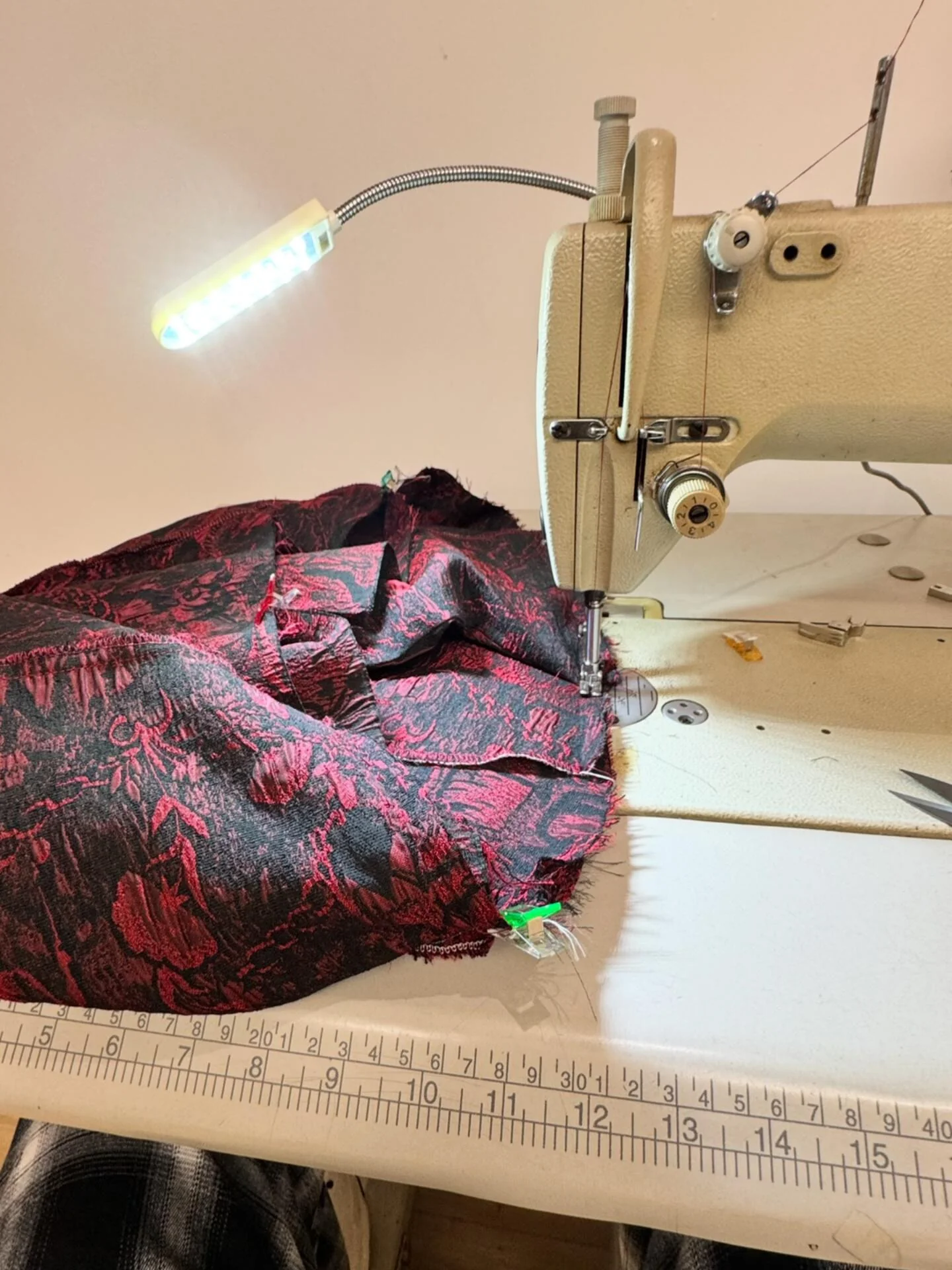 Sewing machine with patterned fabric at a sample work station.