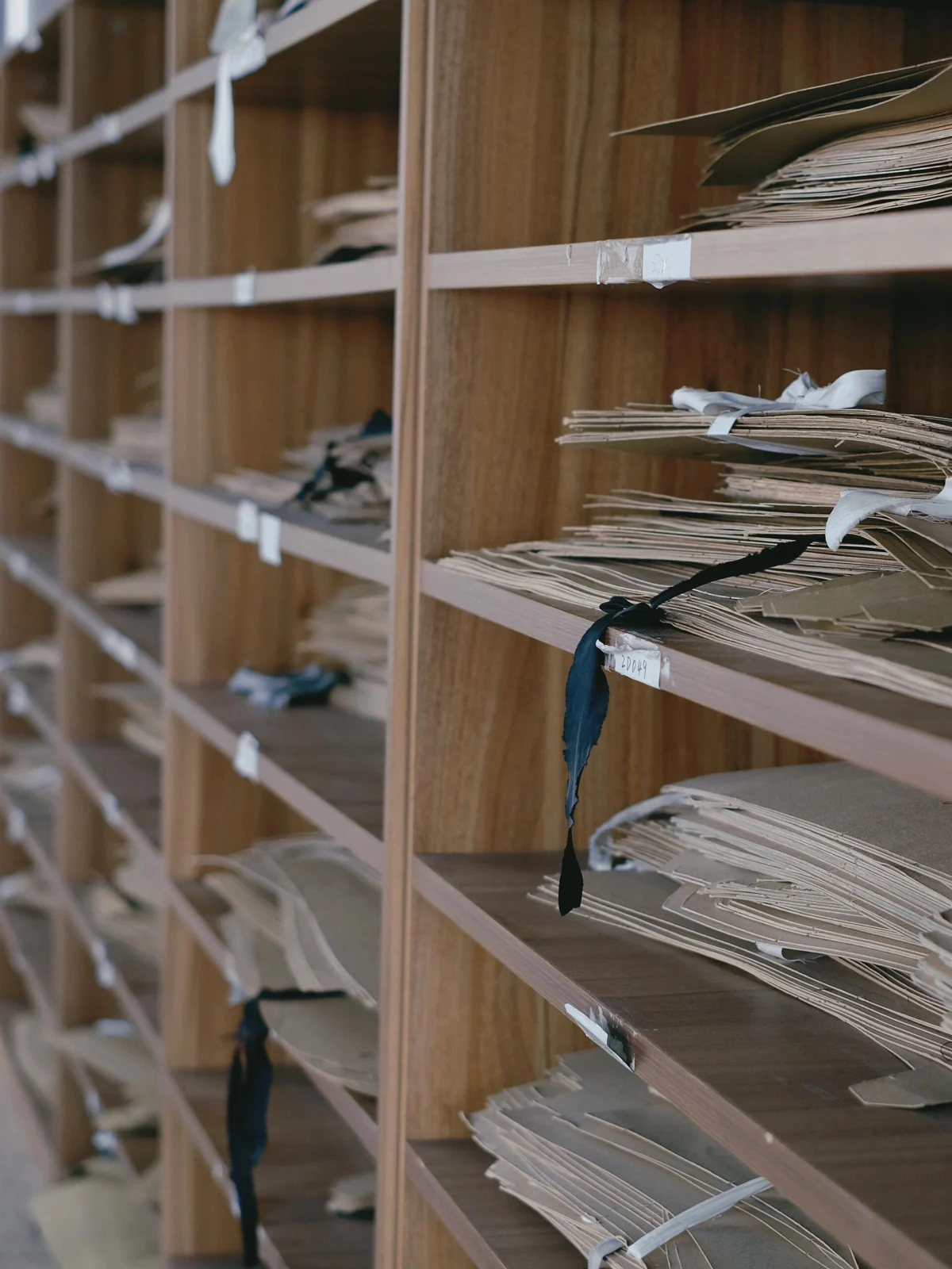 Garment paper patterns stored on workshop shelves.