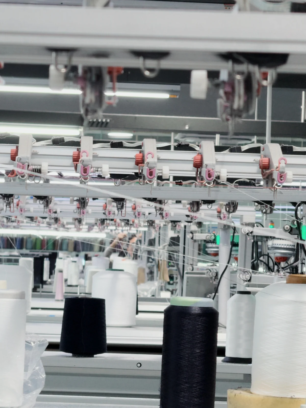 Rows of industrial garment production equipment.