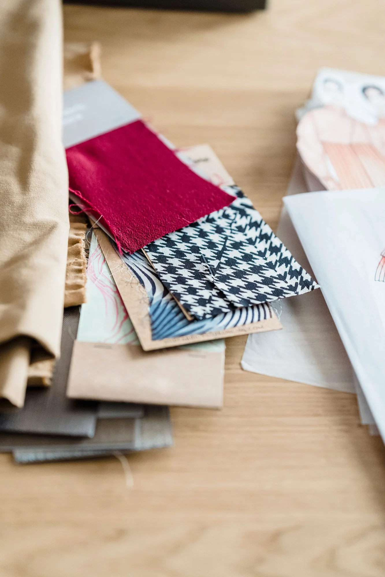 Fabric swatches and colour references on a design table.